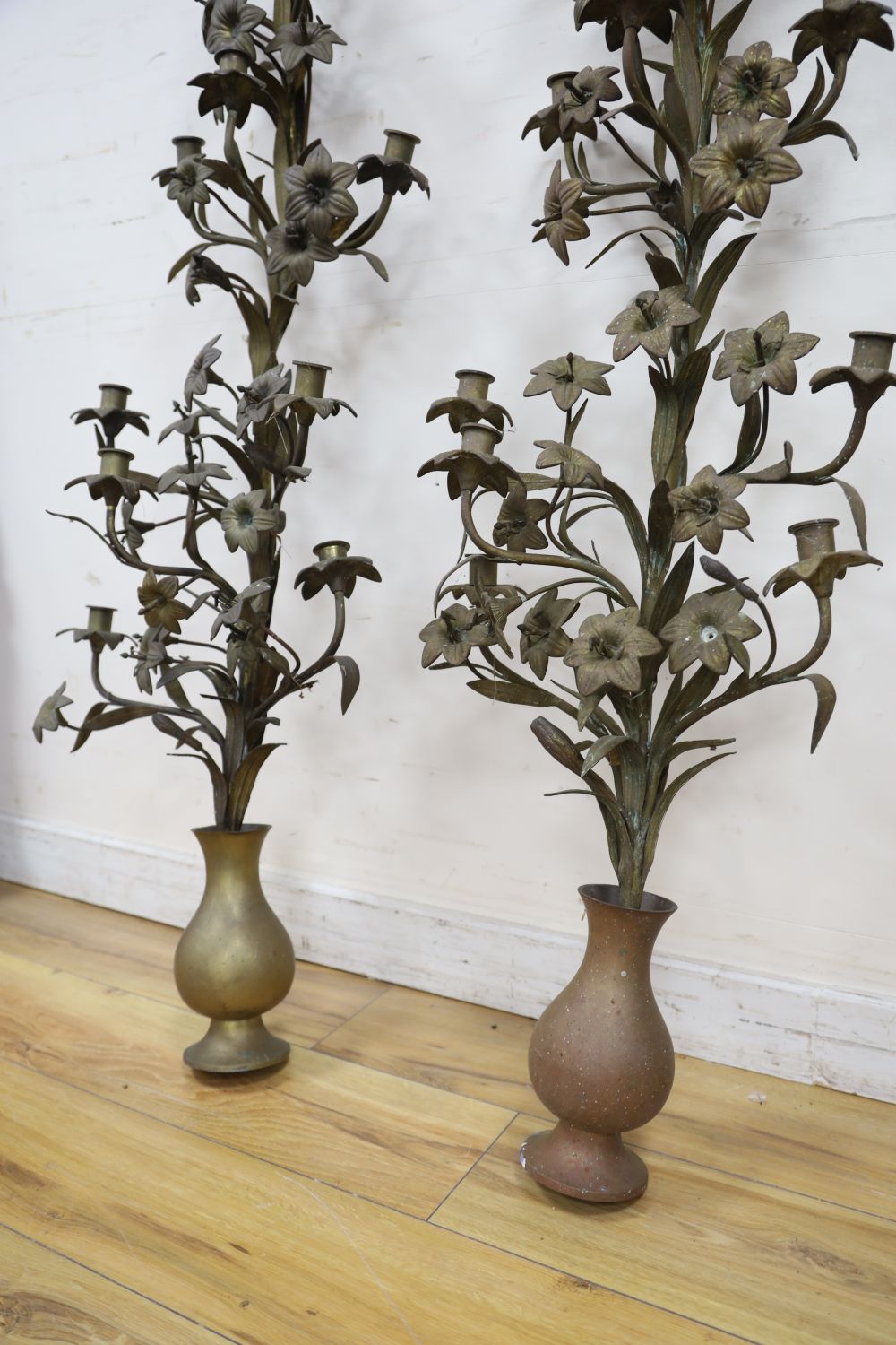 A pair of tall brass candelabra